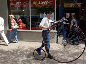 A man walks an old fashioned bicycle down the street at the Watch City Festival celebrating Steampunk in Waltham, Mass. in 2012. Steampunk is a movement that explores the notion of what the world might look like had modern technology been available at the turn of the twentieth century. REUTERS