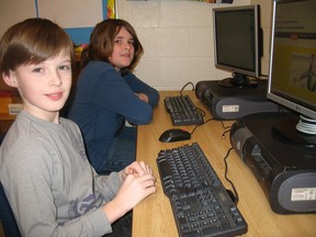 SARAH DOKTOR Simcoe Reformer
Grade 6 students Ewan Lindsay (front) and Aidan Hare (back) use the computer stations in their classroom at St. Joseph's School in Simcoe on Monday. The Brant Haldimand Norfolk Catholic District School Board is in the home stretch of putting in place its 21st Century Teaching and Learning Project.