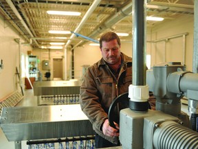 Ed Malcomson, Brockville's wastewater systems supervisor, poses by the controls to a flow gate at the sewage treatment plant in this file photo. (FILE PHOTO)