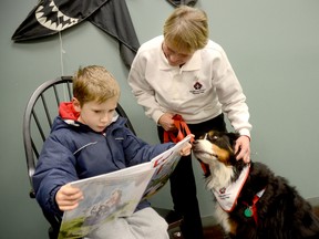 Six year old Eamon Crook of Trenton reads to Grace, a nine-year-old Bernese Mountain Dog at the Quinte West Public Library Trenton branch Thursday afternoon, during the kickoff of the library's Paws for Reading – a therapeutic reading program that uses dogs to help children overcome fears and anxiety of reading aloud. Also shown is Grace's owner and St. John Ambulance volunteer Gail Conrick. 
EMILY MOUNTNEY/TRENTONIAN/QMI AGENCY