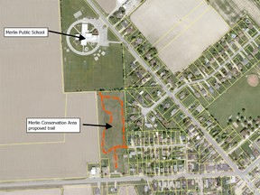 An aerial photograph of Merlin showing where a trail will be constructed on the grounds of the former Merlin District High School (shown with a dashed line). The area is immediately south of Merlin Public School property.