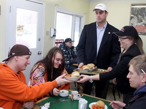 Kingston Mayor Mark Gerretsen and his assistant Christine Thomson serve St. Vincent de Paul clients Katie Roper and Adam LeBlanc during their free lunch on Tuesday.
Ian MacAlpine The Whig-Standard