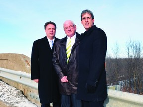 Leeds-Grenville MP Gord Brown, left, Edwardsburgh-Cardinal Mayor Bill Sloan, centre, and Glengarry-Prescott-Russell MPP Grant Crack stand atop a Highway16 rail bridge that will receive a $2.8-million upgrade. (NICK GARDINER/The Recorder and Times)