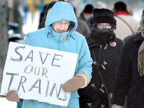 Dozens of protesters including a sign-wielding Dorothy Knight braved bitter cold to voice their displeasure with cuts to VIA Rail Tuesday evening at the Via station. For video of the event, visit www.stratfordbeaconherald.com. (SCOTT WISHART The Beacon Herald)