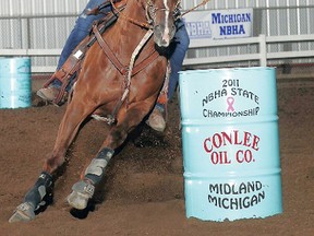 Britney Lemieux and Breezer compete in Michigan in 2011. The pair has emerged 2012 National Barrel Horse Association world qualifiers.