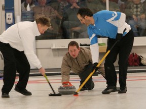 Jason Boyce, skipping Corey Westwood's Gananoque Curling Club entry, releases a rock during semifinal action at the 2010 Whig-Standard Bonspiel at the Royal Kingston Curling Club. Sweeping are Derek MacDonald, left, and Doug Wark. (Whig-Standard file photo)