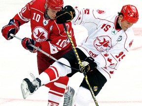Canada's Mike Krushelnyski, right, fights for the puck with Russia's Pavel Bure during an exhibition game Sept. 5, 2012, in St. Petersburg celebrating the 1972 Summit Series and 1987 Canada Cup.  Krushelnyski will play for the NHL Alumni on Friday at Memorial Arena. (ALEXANDER DEMIANCHUK/Reuters)