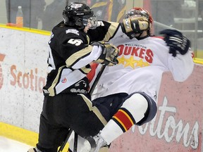 Trenton Golden Hawks' Nick Marinac flattens a Wellington Dukes player during the Dukes' 3-2 shootout win Friday at the Essroc Arena.