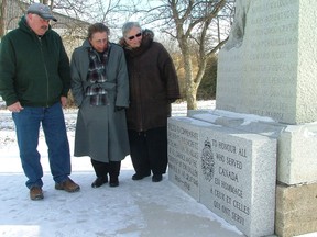 Oil Springs Mayor Ian Veen, Royal Canadian Legion, Oil Springs branch 535 member Suzy Gonerman, and Sarnia-Lambton MP Patricia Davidson inspect a new, inscribed stone at the village cenotaph. The MP gave the village a $4,700 cheque on Jan. 22 from Veterans Affairs Canada to help pay for the monument's restoration in July. (DAVID PATTENAUDE, QMI Agency)