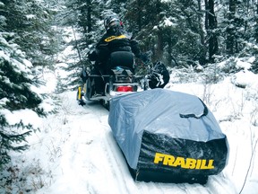 My friend Jamie Bruce headed into a back lake to catch crappies earlier this winter.  Notice the auger rack on the back of his snowmobile and the sled that is also an ice shelter for hauling gear. 
JEFF GUSTAFSON/Daily Miner and News