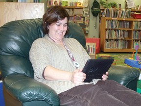 Kenora Public Library children’s librarian Crystal Alcock reads from an iPad on the lower level of the Main Street branch. While e-Book lending is on the rise locally, librarians say young people are surprisingly behind on the trend.
JON THOMPSON/Daily MIner and News