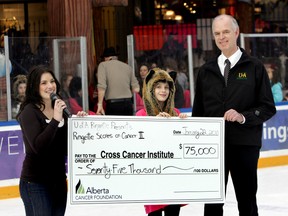 Alberta Cancer Foundation’s Charissa Spencer, left, receives a cheque for $75,000 from ringette player Taylor Hrynchuk and University of Alberta Pandas’ coach Paul Hotke after the 2011 edition of Ringette Scores on Cancer, a tournament in support of cancer research.  Hotke hopes to repeat the feat. FILE PHOTO QMI AGENCY