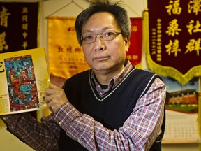 Stephen Tsang holds up a calendar showing the Year of the Snake at the Chinese Benevolent Association Sunday. CODIE MCLACHLAN QMI AGENCY