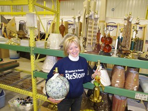 Barb Ransome, manager of Habitat for Humanity's of ReStore, shows off several lamps that have been donated to the retail charitable organization. (HEATHER RIVERS/WOODSTOCK SENTINEL-REVEW)