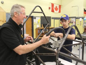 Marc Claege, left, the transportation technology teacher at La Salle Secondary School, and student Brandon Hallett look over the frame of the racing car the class is building.
Michael Lea The Whig-Standard