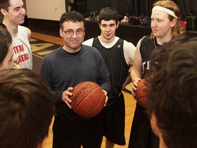 St. Basil Saints head coach Lou Mazzuca chats with his team during a practice earlier this week.