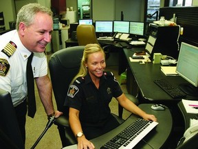 Kingston Fire and Rescue’s new fire chief Rhéaume Chaput checks out the communications division with Natalie Baker, one of the departments communications technicians, in the O’Connor Street headquarters. Chaput was sworn in on Jan. 7 following the retirement of outgoing Chief Harold Tulk.      Rob Mooy - Kingston This Week