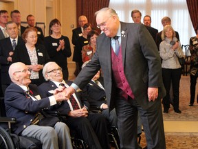 Lieutenant Governor Donald Ethell shakes hands with veterans in attendance of the Government House Centennial Celebration on Wednesday, Jan. 23, 2013. DALE BOYD/SPECIAL TO THE EXAMINER