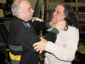 Keith Burnett playing the role of Tony, a former professional director, grabs John Harris, playing Tony's arch rival William Marcus, in Theatre Kent's latest production Swashbuckled. (Submitted photo)