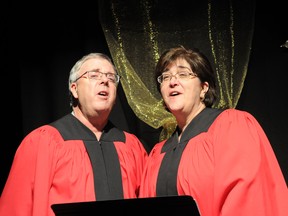 Rick Hyrciuk and Deb Haiworonsky perform as part of the 50 and Proud of It chorus. (Diana Rinne/Daily Herald-Tribune)