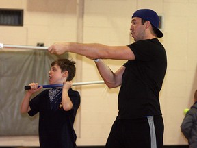 Edmonton Rush first overall draft pick Mark Matthews teaches a student lacrosse fundamentals in a visit to Brentwood school last Thursday. Photo by Shane Jones?Sherwood Park News/QMI Agency