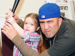 Deanna Lale, three-year-old daughter of David and Danielle Lale of Union, gets some tips Thursday from Gar "The Batting Stance Guy" Ryness at the afternoon reception for the 35th annual Sports Spectacular. (MARK BUTTERWICK / St. Thomas Times-Journal / QMI AGENCY)
