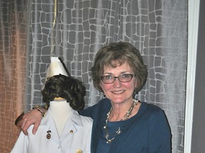 Karen Scott at her retirement party Jan. 19 next to her graduation uniform complete with nurse’s cap and grad pin.
DIANE HEIDA/FOR THE Daily Miner and News