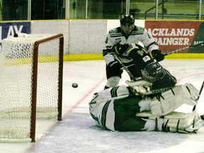 The Saints Tyler Busch gets plowed under by a Drayton Valley defender as he fires a shot that goes just wide in second period action of the Saints 4-1 win.