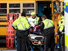 A student involved in a bus accident on Sydenham Road is transfered into a waiting ambulance on Friday morning.
Ian MacAlpine The Whig-Standard