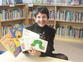Erin McLeod holds up some of her favourite children’s books she’ll share at an upcoming presentation at Bruce Mines Public Library, east of Sault Ste. Marie, Ont.