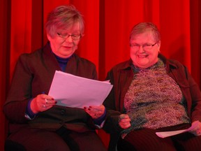 Peggy Cooper (left) reviews her notes with Sandra Houston before the start of a funding announcement at Kiwanis Community Theatre Centre on Friday, Jan. 25, 2013.