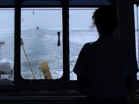 A Coast Guard officer gets a good view as the Canadian Coast Guard Ship Griffon escorts a commercial tanker, the Algocanada, through the ice from the southeast shoal of Lake Erie toward Windsor Friday. SUBMITTED PHOTO