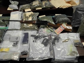 A substantial amount of marijuana, a quantity of methamphetamine, prescription drugs, cash and two firearms were seized in a drug bust near Langton on Friday. (Norfolk OPP photo)