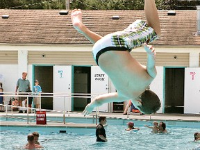 11-year-old Andrew Hazell does a flip as he jumps into the Paris Community Pool in Lions Park at its official opening day in July, 2012. (Expositor file photo)