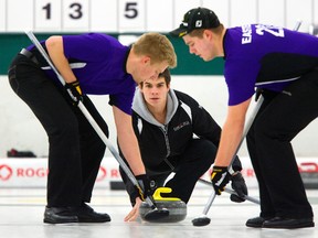 Aaron Squires, with sweepers David and Curtis Easter. (MIKE HENSEN The London Free Press)