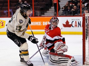 London Knights' Seth Griffith, left, scores on Ottawa 67s' Jacob Blair, right, during a penalty during the second period of OHL hockey action at Scotiabank Place Thursday, Jan. 24, 2013.  (Darren Brown/Ottawa Sun/QMI Agency)