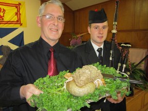 Rob Reid had the honour of parading the haggis at the Burns Night Celebration at Knox Presbyterian Church in Port Dover Friday. With Reid is his son, Ben, who provided the bagpipe accompaniment. (MONTE SONNENBERG Simcoe Reformer)