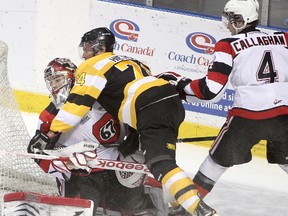 Kingston Frontenacs’ Luke Hietkamp gets up close and personal with Ottawa goalie Jacob Blair as the 67’s Sean Callaghan tries to pull him away during Friday night's Ontario Hockey League game at the K-Rock Centre. The 67’s won 5-4 in a shootout. (Michael Lea/The Whig-Standard)