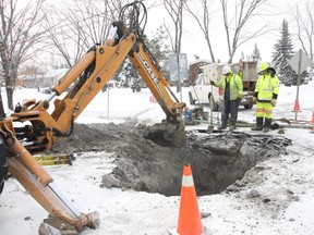 JOHN LAPPA The Sudbury Star
Marcel Gagnier, left, and Jesse Bertrand, of the City of Greater Sudbury Water/Wastewater department work on a water main break at Stewart Drive and Millwood Crescent on Wednesday. City crews had to dealwith four water main breaks in the past few days.