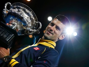 Novak Djokovic of Serbia poses with the Norman Brookes Challenge Cup after defeating Andy Murray of Britain in their men's singles final match at the Australian Open tennis tournament in Melbourne. REUTERS/Damir Sagolj
