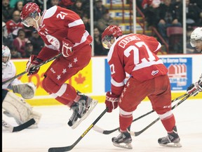 Soo Greyhounds forward Brandon Alderson (21) jumps out of the way as centre Nick Cousins (27) prepares to unleash a shot against the Oshawa Generals Saturday night.