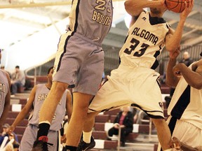 Algoma’s Jovain Wilson (33) goes up for a shot while being defended by Sheridan’s Jahmal McQueen.