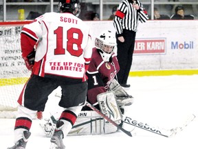 Chatham Maroons goalie Darien Ekblad makes a save while Leamington Flyers' Chris Scott looks for a rebound in the first period Sunday at Memorial Arena. (MARK MALONE/The Daily News)