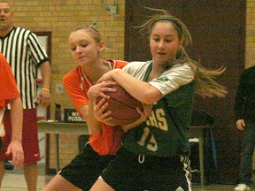Rhea Van Helden, left, of the Chatham Christian Sparks, and Taylor Kewley of the Georges P. Vanier Tigers vie for possession of the ball in the opening game of the annual Jim Dillon Memorial Basketball Tournament, played Jan. 24 at John McGregor Secondary School. Vanier won 35-32 in overtime. In other games played on the first day of the senior elementary school girls tournament, St. Vincent beat St. Ursula 24-22, Vanier beat St. Anne 48-25, Holy Trinity of Sarnia defeated St. Ursula 35-19, Chatham Christian defeated St. Anne 44-31 and Holy Trinity beat St. Vincent 49-26.