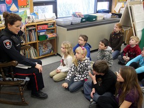 Kingston Police Const. Carolyn Gauthier reads to Anne Barratt's grade two/three class at St. Martha Catholic School during Literacy Day on Monday.
Ian MacAlpine The Whig-Standard
