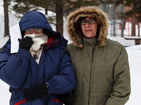 Ruth Vinluan, left, and Karen Mann look to be freezing during Ice on Whyte in Edmonton, Alta., on Monday, Jan. 28, 2013. Temperatures are projected to plummet below -30C with windchill tomorrow. Codie McLachlan/Edmonton Sun/QMI Agency