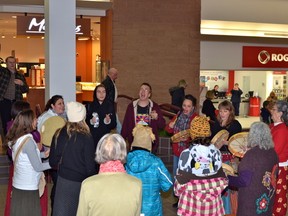 A group of Idle No More demonstrators drum and sing in a circle in Heritage Place Shopping Centre. About 60 people took part in the event.