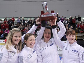 Team Jones, from left, skip Jennifer Jones, third Kaitlyn Lawes, second Jill Officer and lead Dawn Askin hoist the championship trophy after defeating Barb Spencer 9-3 in nine ends to win the Manitoba Scotties curling final in Stonewall, Man., on Sunday. Jones’ team will play at the Scotties Tournament of Hearts national championship in Kingston, Feb. 16-24. (Brian Donogh/QMI Agency)