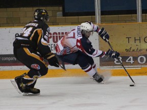 Sam Blanchet of the North Bay Trappers puts on the brakes to try and get away from Kealy Cummings of the Abitibi Eskimos during first period action at the Memorial Gardens Sunday afternoon. The Trappers won the game 4-1.