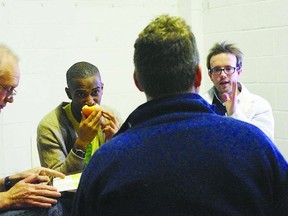 Director Alan Dilworth, (back to camera), speaks with (l-r) Nigel Bennett, Ayinde Blake and William Matthews as they rehearse a scene from Blue/Orange playing at the Baby Grand Theatre until Feb. 16.
